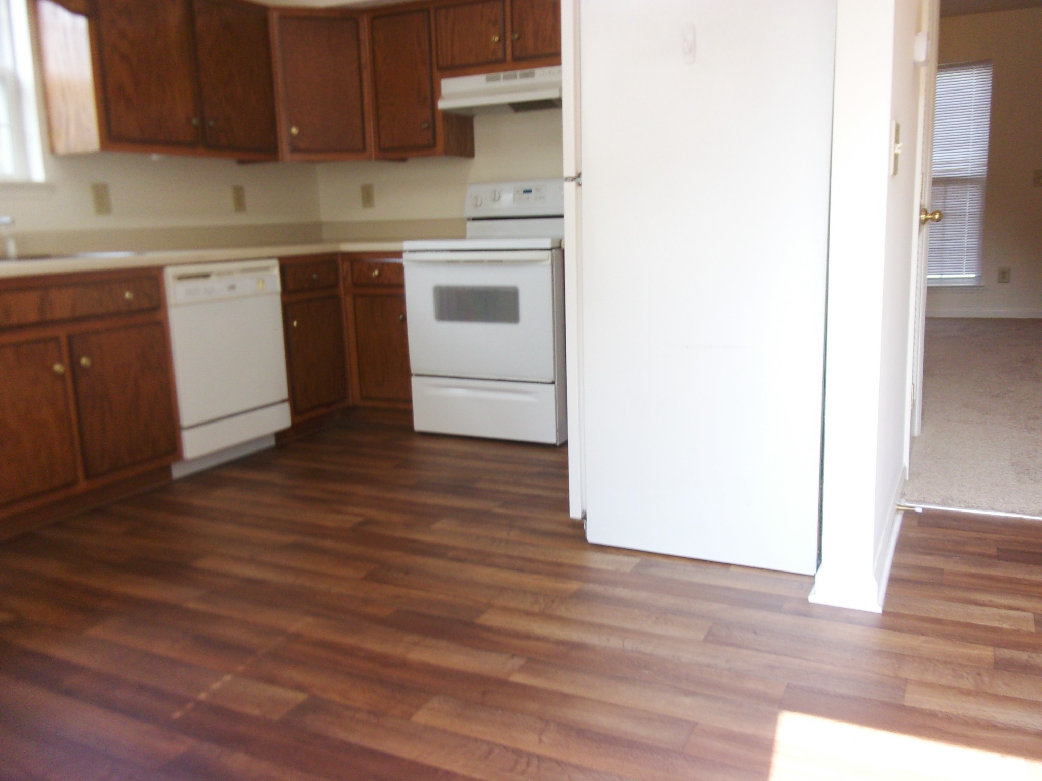235 Hidden Acres, Unit A Lebanon, TN 37087 - Photo 4 of 14 a kitchen with granite countertop wooden floors and white stainless steel appliances