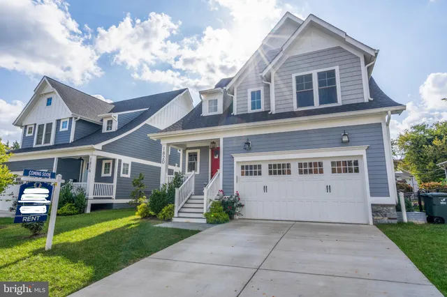 a view of house with yard and front view of a house