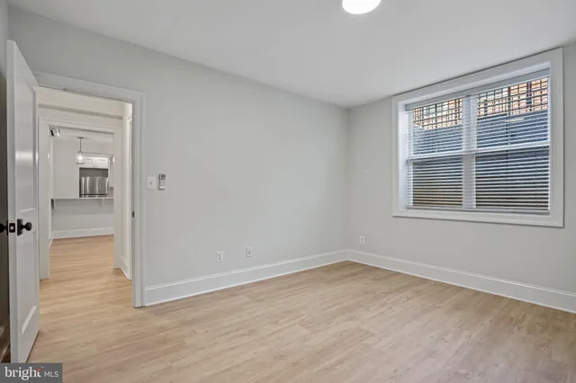 wooden floor in an empty room with a window