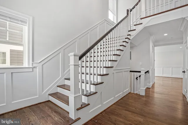 a view of entryway with wooden floor and stairs