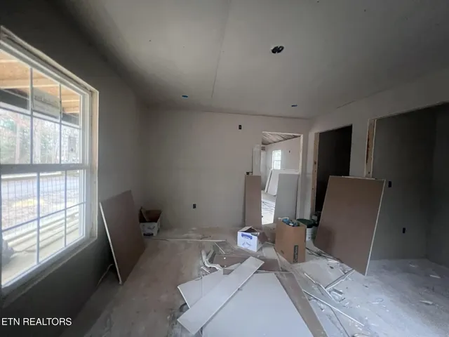a view of a workspace with furniture and a window