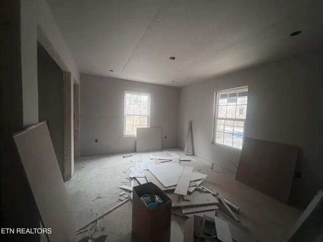 a living room with furniture and windows