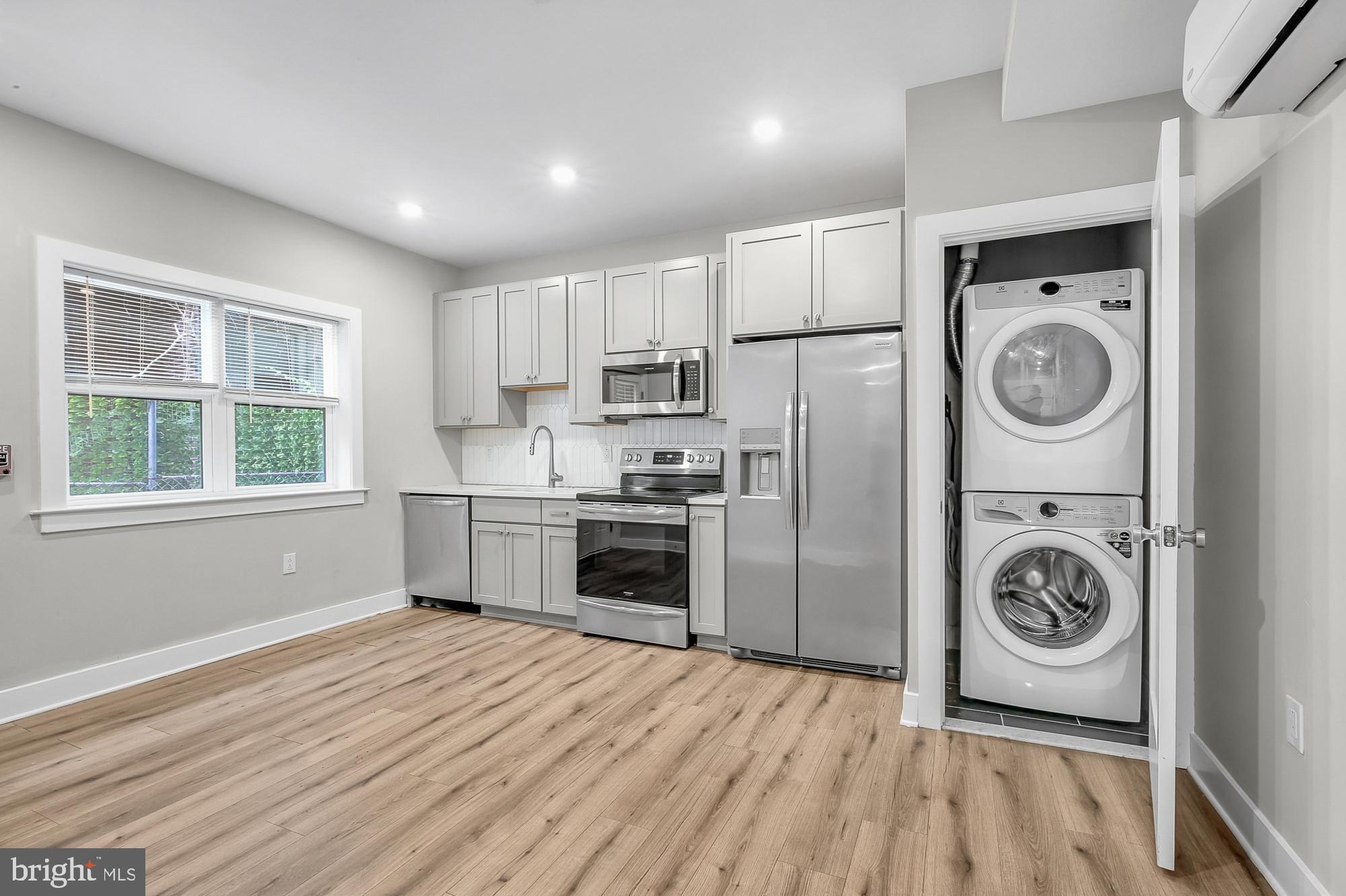 a kitchen with a refrigerator a washer and dryer