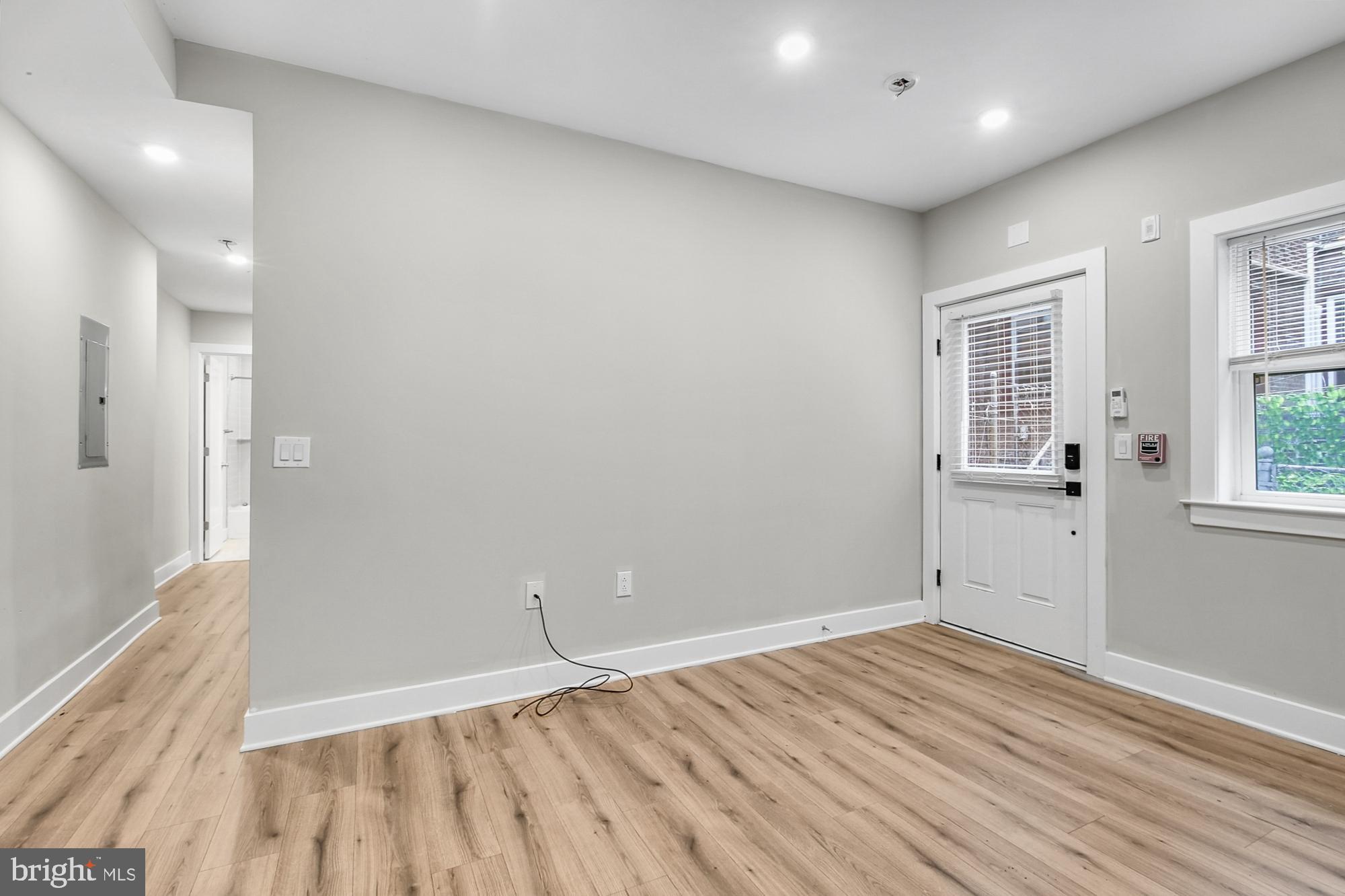 5007 Pentridge Street, Unit 1C Philadelphia, PA 19143 - Photo 6 of 14 wooden floor in an empty room with a window