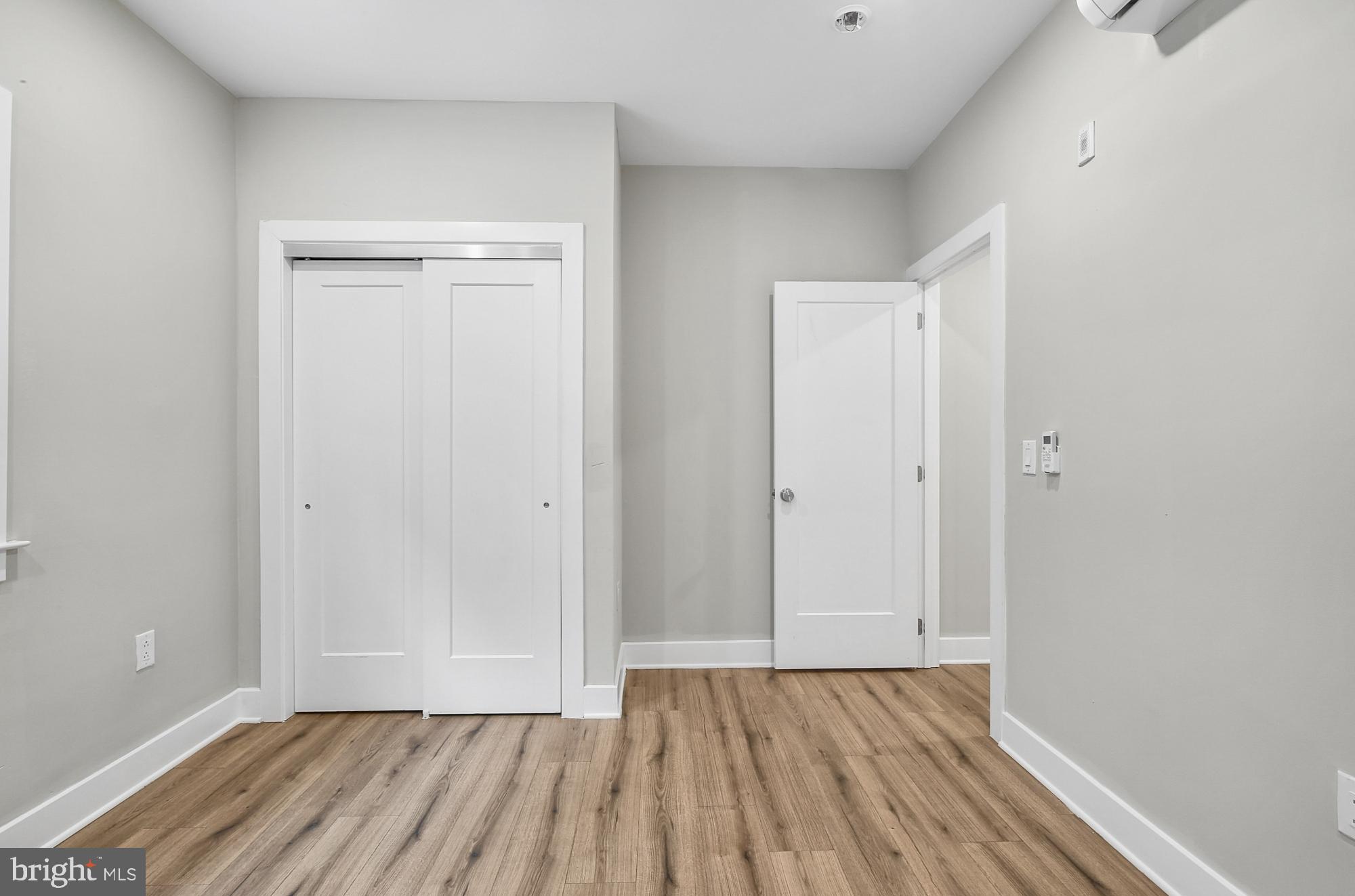 5007 Pentridge Street, Unit 1C Philadelphia, PA 19143 - Photo 10 of 14 a view of an empty room with wooden floor