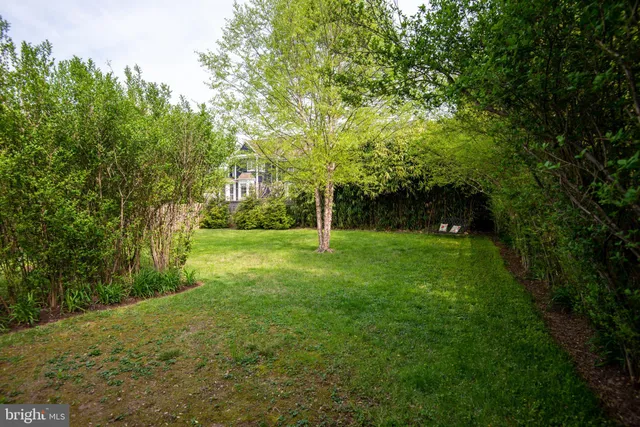 a front view of a house with swimming pool and porch