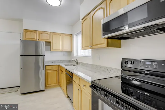 a kitchen with a stove and a refrigerator
