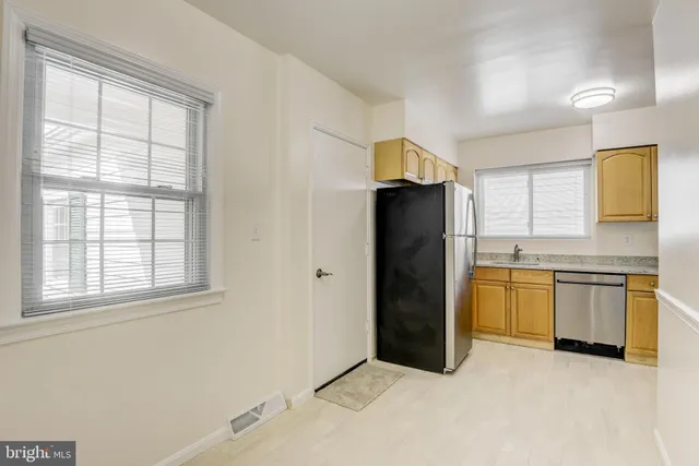 a kitchen with stainless steel appliances granite countertop a refrigerator and a stove top oven