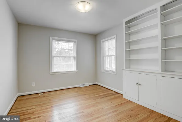 a view of a room with wooden floor