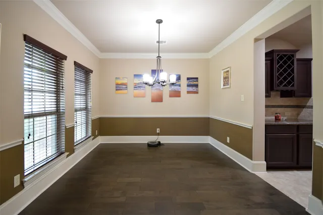 a view of an empty room with window and cabinet