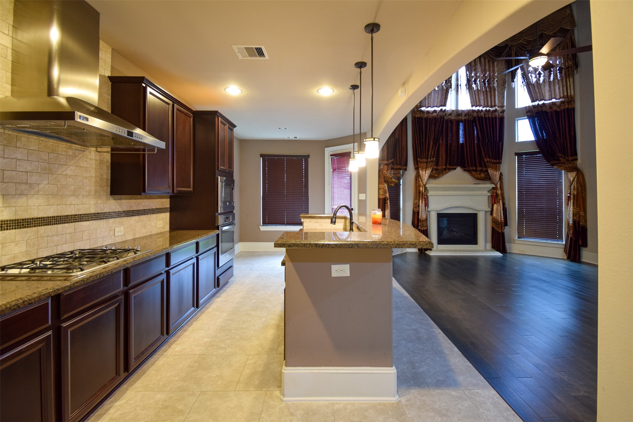 27363 Pendleton Trace Drive Spring, TX 77386 - Photo 5 of 26 a kitchen with stainless steel appliances granite countertop a stove a sink dishwasher and a microwave oven with large wooden cabinets