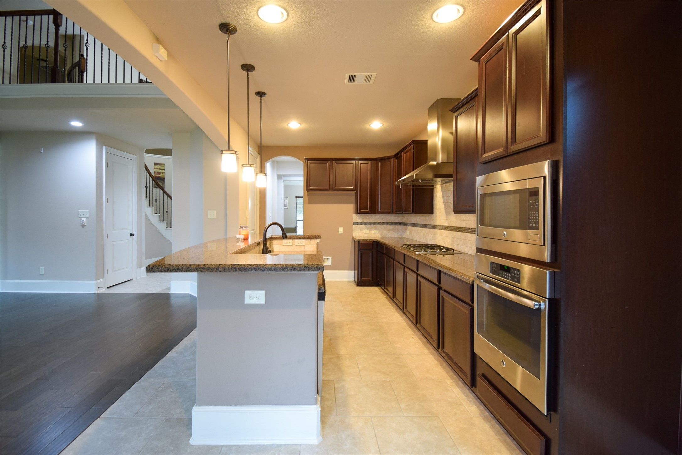27363 Pendleton Trace Drive Spring, TX 77386 - Photo 6 of 26 a large kitchen with stainless steel appliances kitchen island a large counter space a sink and cabinets