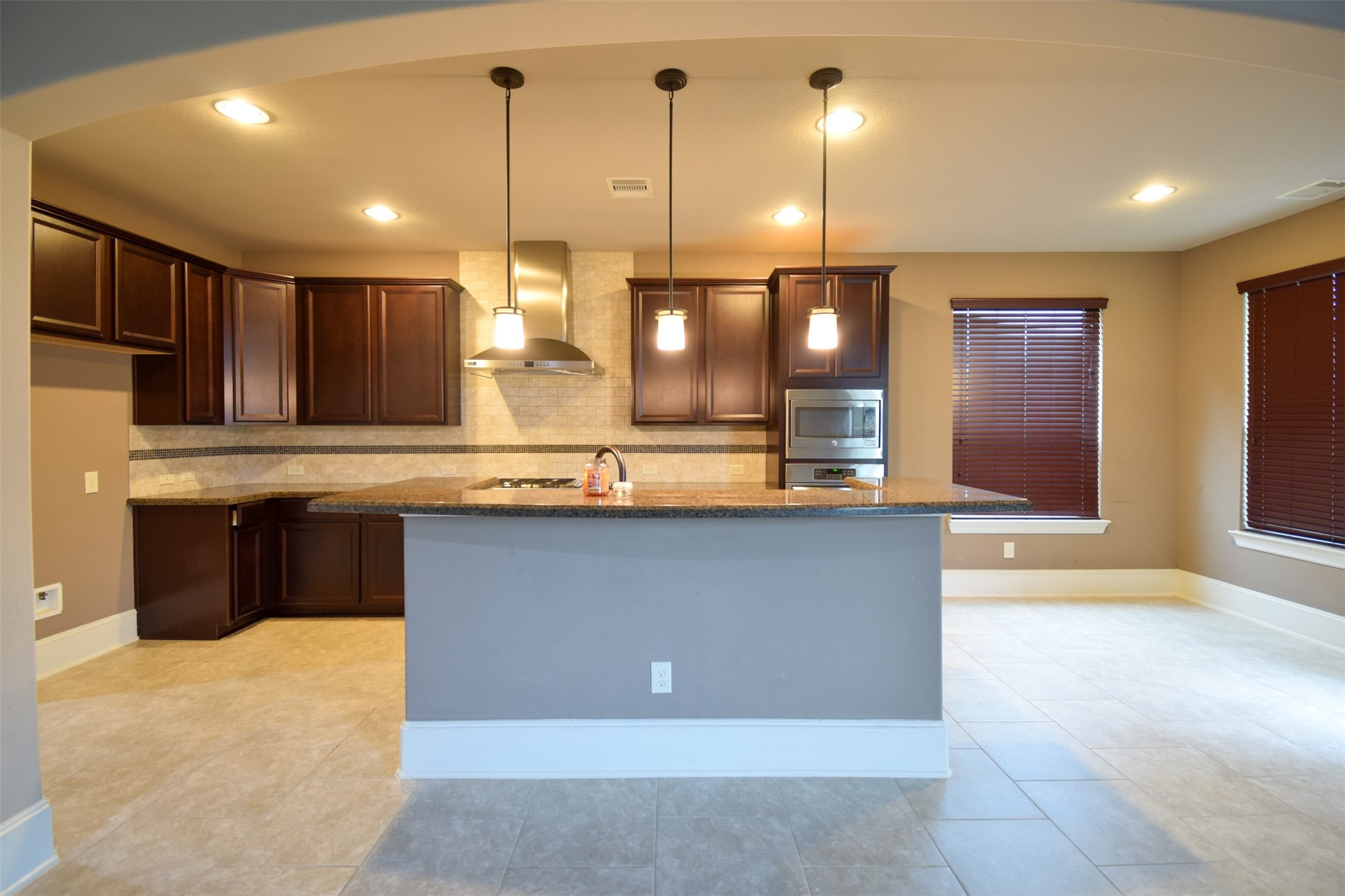 27363 Pendleton Trace Drive Spring, TX 77386 - Photo 7 of 26 a kitchen with kitchen island a counter top space appliances and cabinets