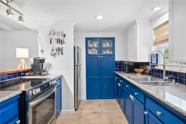 a kitchen with a stove and a sink