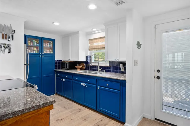 a kitchen with granite countertop a sink and cabinets