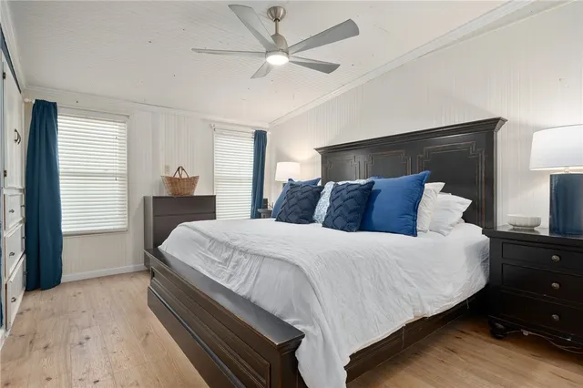 a bedroom with a bed and a ceiling fan