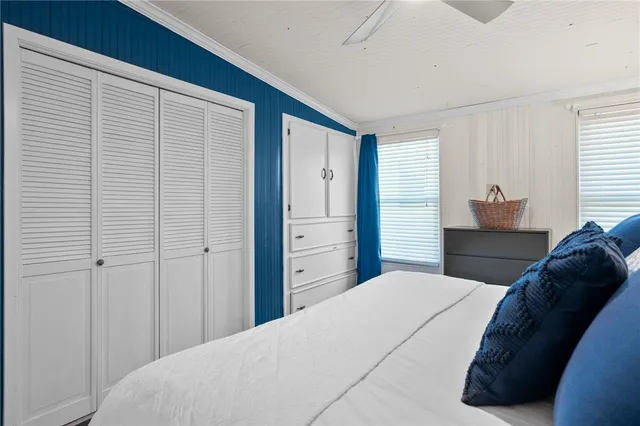 a bedroom with a bed and a closet