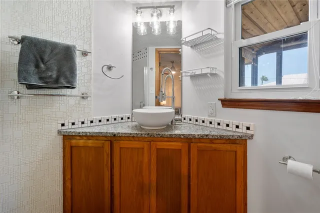 a room with a sink and a mirror