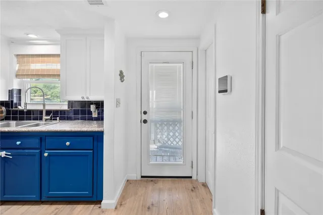 a view of a kitchen from a hallway