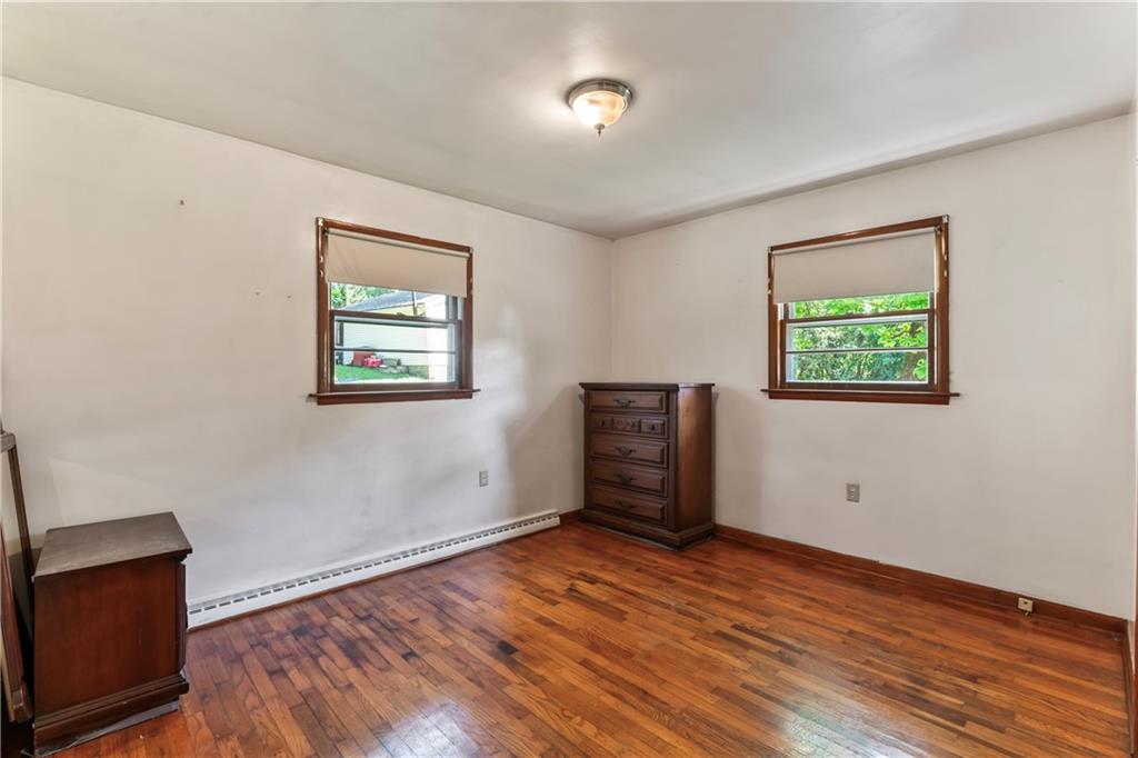 530 Helen Street Rochester, PA 15074 - Photo 11 of 22 an empty room with wooden floor cabinet and windows