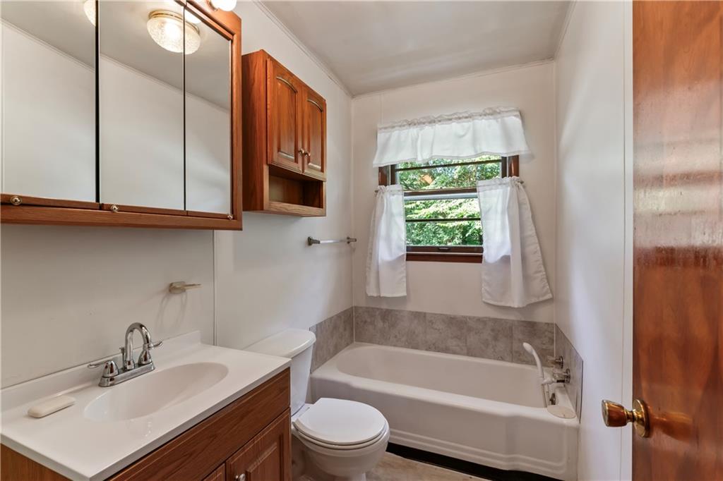 530 Helen Street Rochester, PA 15074 - Photo 8 of 22 a bathroom with a sink a bathtub and window