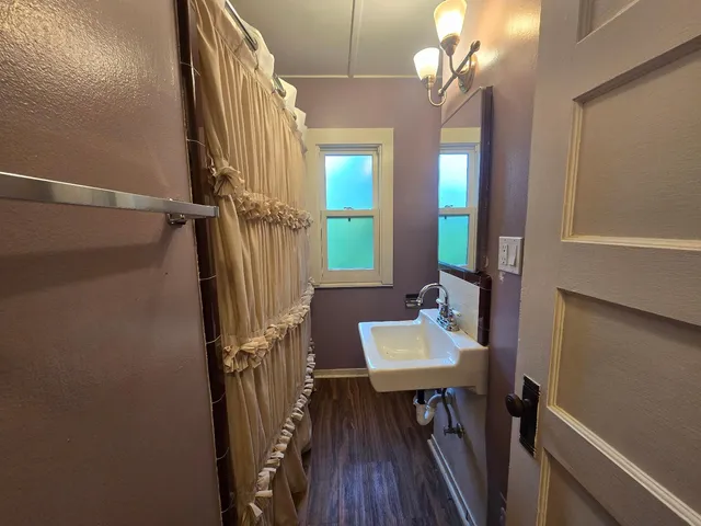a view of a livingroom with furniture and hardwood floor