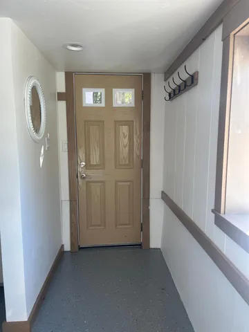 a view of an entryway with wooden floor