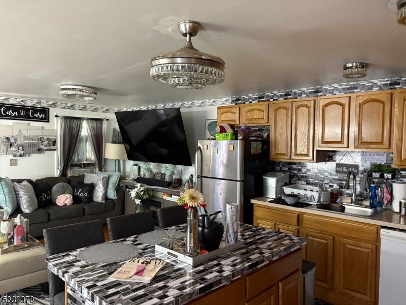 49 Hope Street Passaic, NJ 07055 - Photo 4 of 9 a kitchen with stainless steel appliances granite countertop a sink dishwasher stove and refrigerator with wooden floor