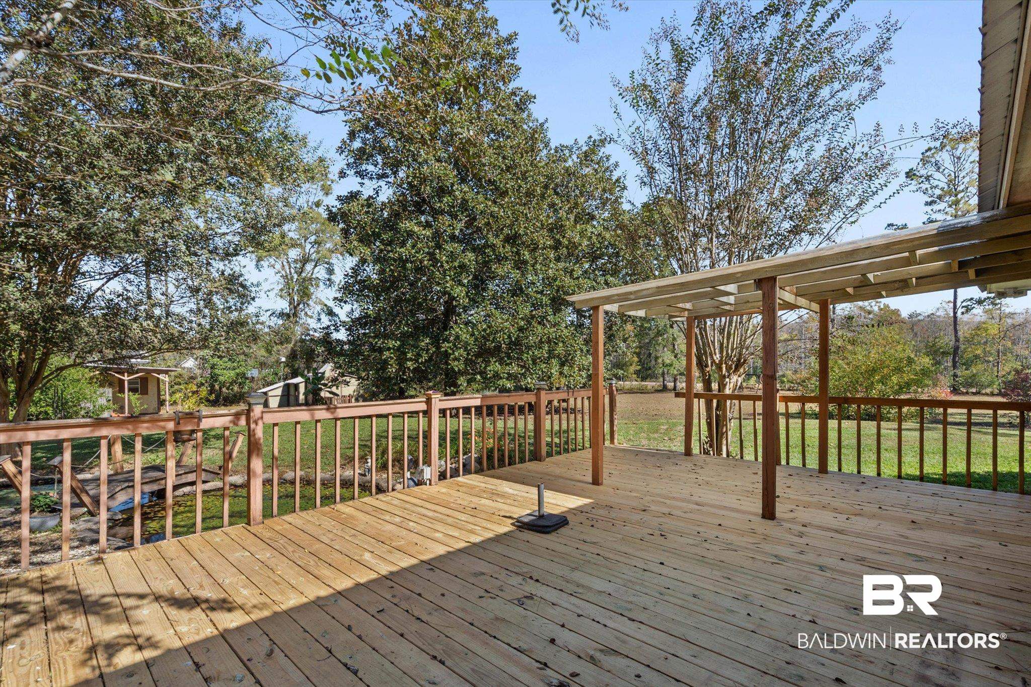 180 Creax Road Axis, AL 36505 - Photo 24 of 35 Wooden deck featuring a lawn
