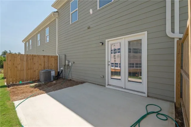 a view of a house with a door and wooden fence