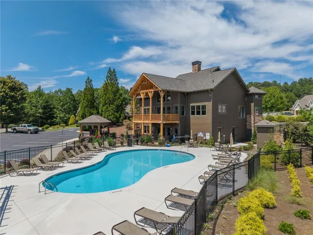 a view of a swimming pool with lounge chairs in patio