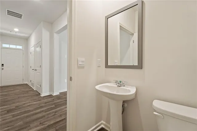 a bathroom with a sink a mirror and a toilet