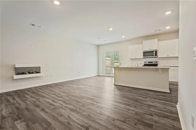a kitchen with stainless steel appliances a refrigerator sink and microwave