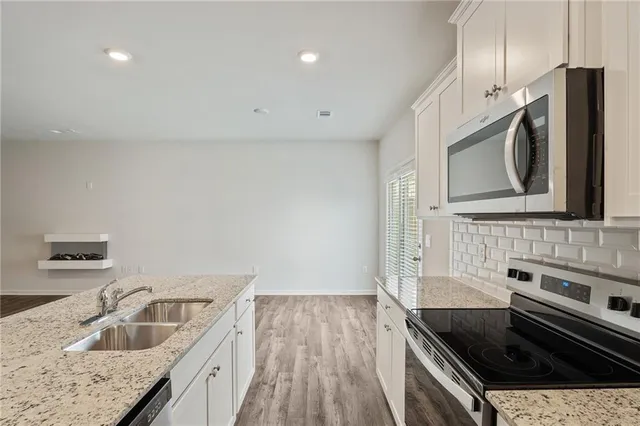 a kitchen that has a sink and a stove