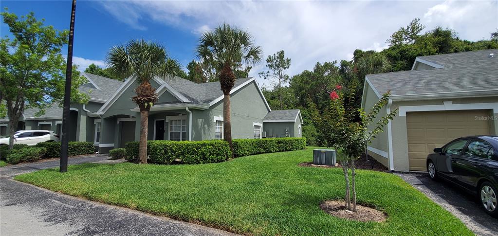 3653 Kings Road, Unit 106 Palm Harbor, FL 34685 - Photo 1 of 1 a view of a house with a garden and plants