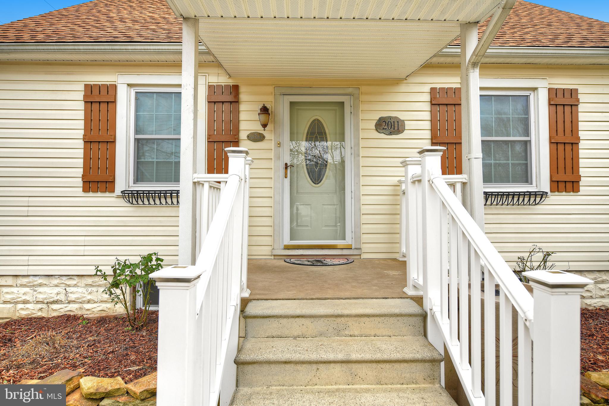 2011 Oakland Road Baltimore, MD 21220 - Photo 4 of 33 Pretty white railing, covered porch & NEW ROOF!