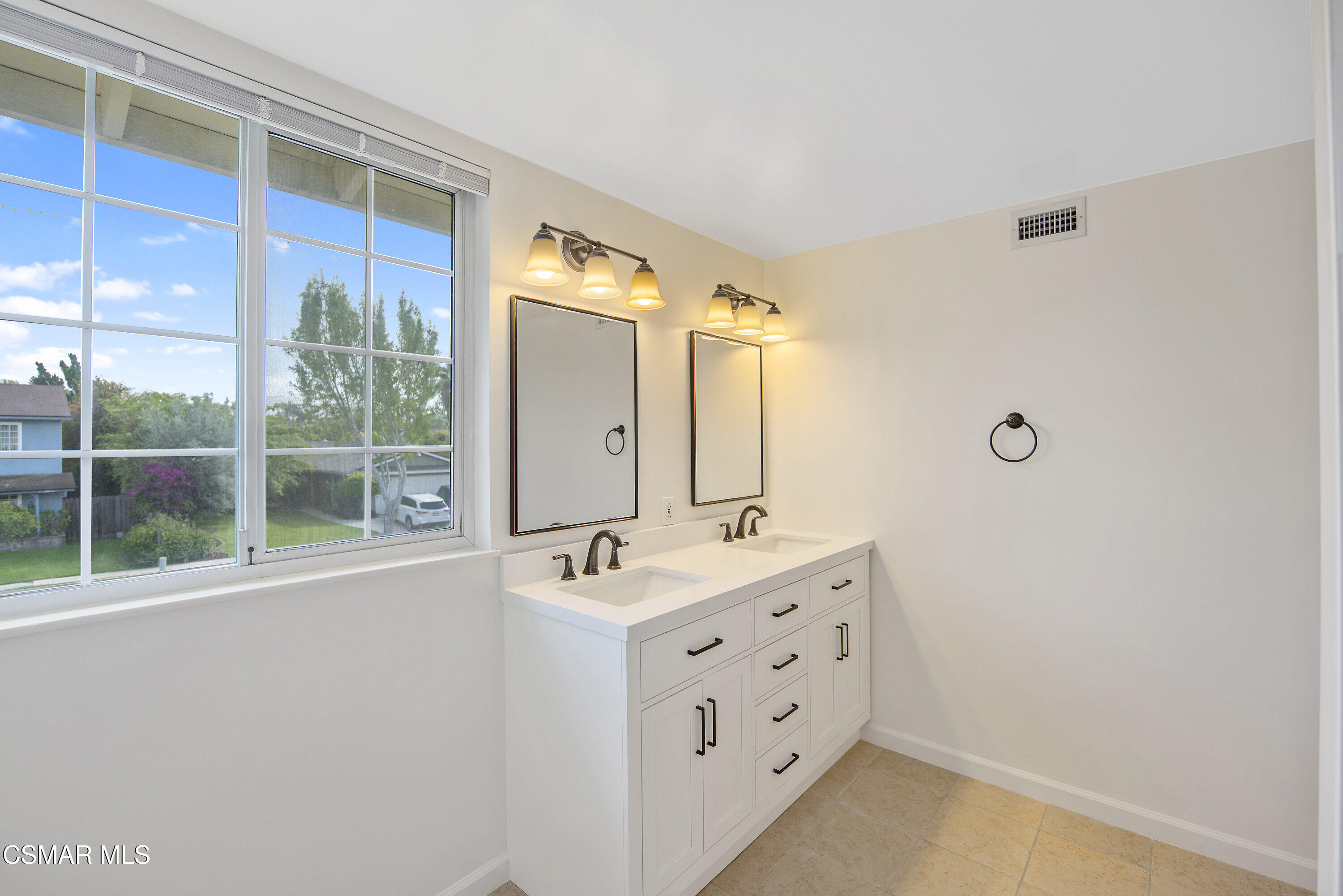 2087 Rhoda Street Simi Valley, CA 93065 - Photo 15 of 22 a bathroom with a double vanity sink a mirror and next to a window