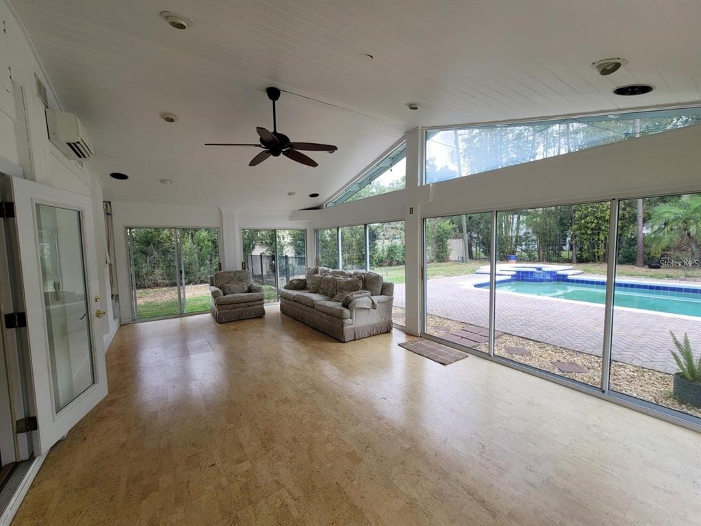 11129 Lake Butler Boulevard Windermere, FL 34786 - Photo 11 of 17 a living room with furniture and a floor to ceiling window