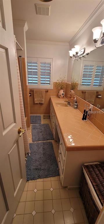 11129 Lake Butler Boulevard Windermere, FL 34786 - Photo 6 of 17 a bathroom with a sink a toilet a mirror and window