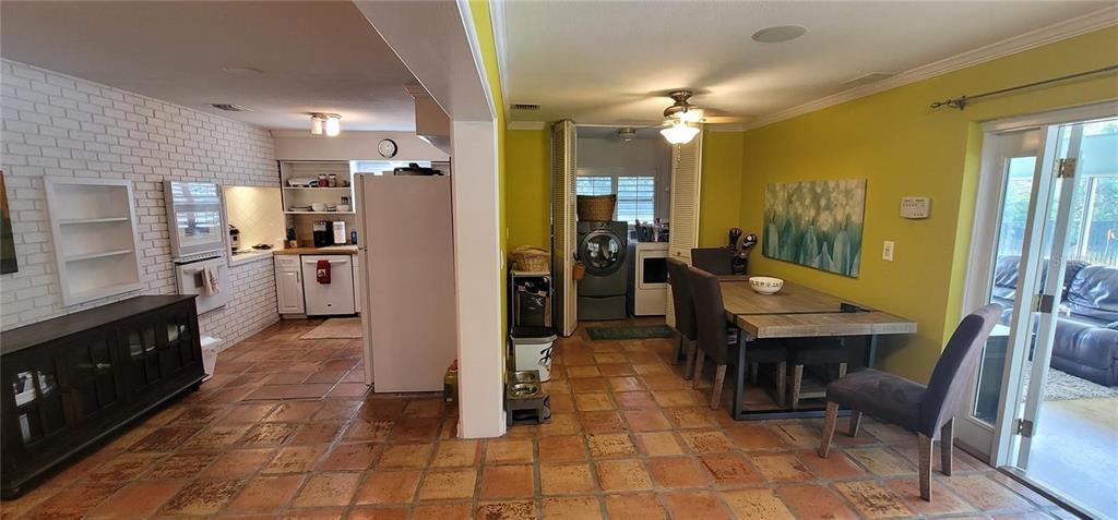 11129 Lake Butler Boulevard Windermere, FL 34786 - Photo 7 of 17 a kitchen with stainless steel appliances kitchen island granite countertop dining table chair and a refrigerator