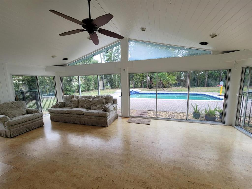 11129 Lake Butler Boulevard Windermere, FL 34786 - Photo 10 of 17 a living room with furniture and a floor to ceiling window