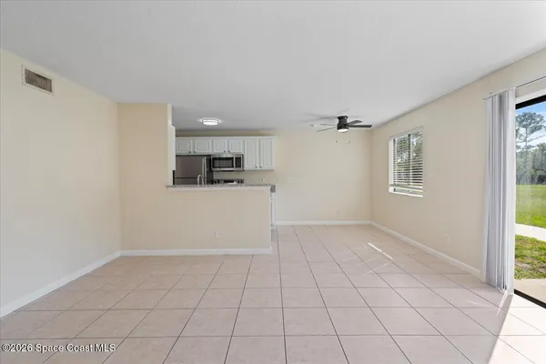 a view of a livingroom with an empty space and a window