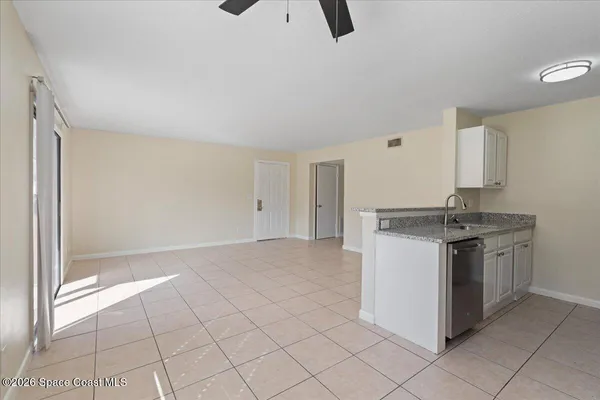 a kitchen with granite countertop a sink and a stove