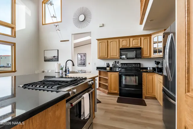 a bedroom with a bed and a large mirror with a wooden floor