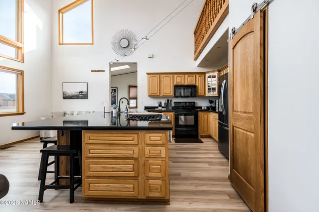 a kitchen with stainless steel appliances granite countertop a sink and cabinets