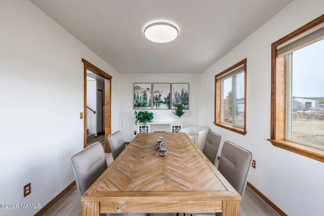 a view of a hallway with wooden floor and windows