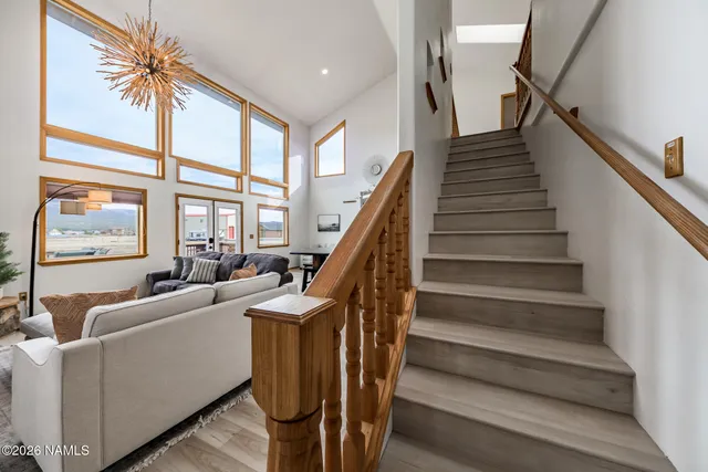 a spacious bathroom with a double vanity sink a mirror and a shower