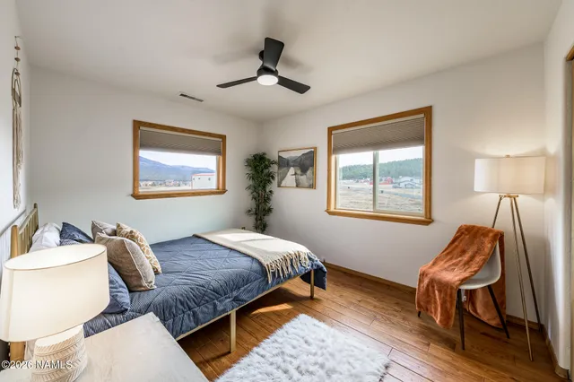 a view of a hallway view with wooden floor and furniture