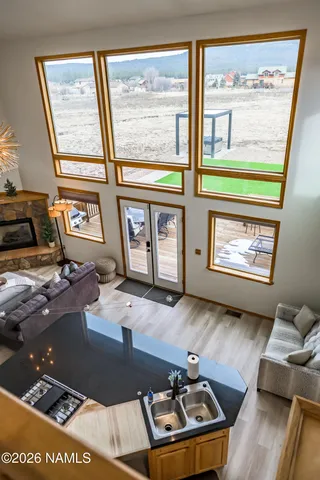 a view of a balcony dining space with furniture and city view