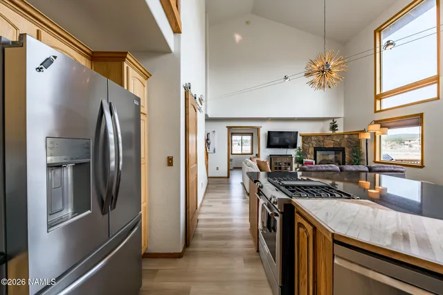 a kitchen with stainless steel appliances granite countertop a stove and a microwave